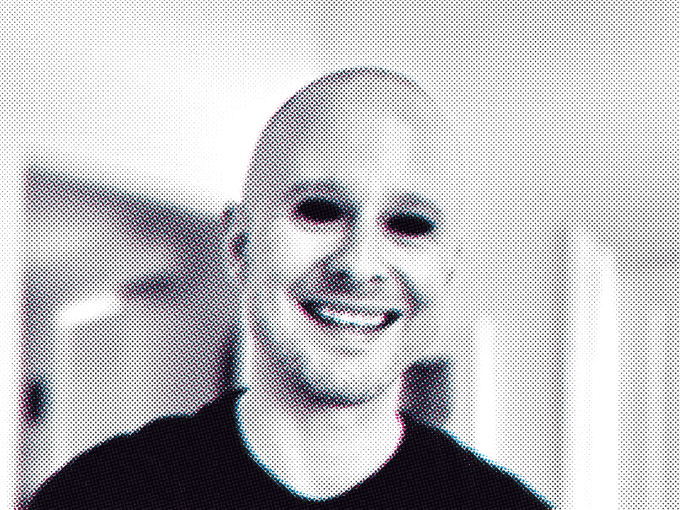 Karl Sheridan smiling, in a black t-shirt